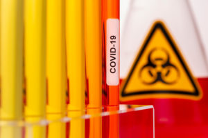 Test tubes with corona viruses with biohazard in the laboratory Test tubes with corona viruses with biohazard in the laboratory